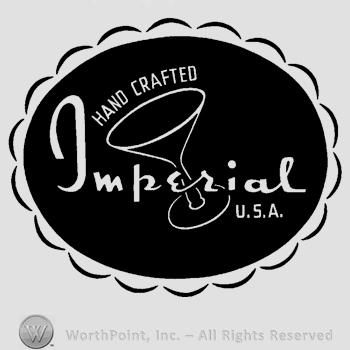 A round design with a glass inside, the text Hand Crafted Imperial U.S.A. written in uppercase and lowercase letters.