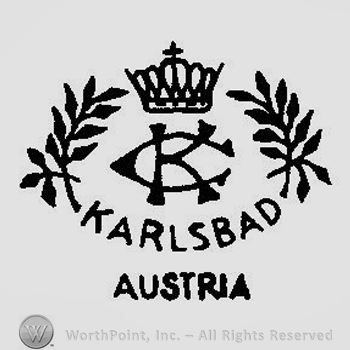 A Crown above the initials CK overlapping surrounded by two branches and the text Karlsbad Austria