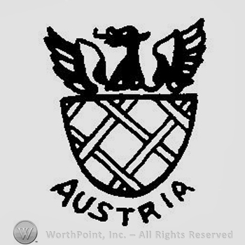 A shield with crossed lines with a half bird above with the wings spread and the word Austria below