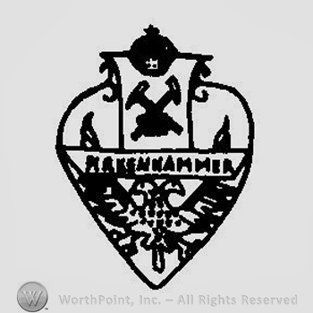 A heart shape with a crown in the upper part, two crossed hammers and a two headed eagle in the lower part, crossed by the word Markenhammer