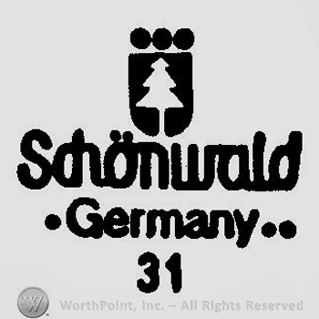 A shield with a fir tree and the words Schonwald Germany 31