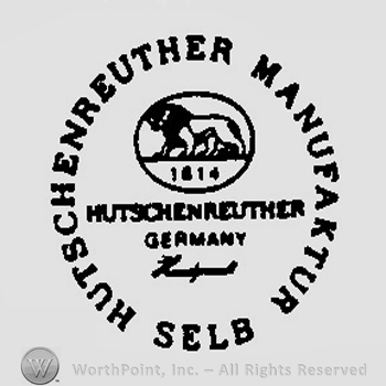 A lion and the number 1814 inside an oval above the words Hutschenreuther Germany written in uppercase letters surrounded by the text Hutschenreuther Manufaktur Selb in uppercase letters and in a circle shape