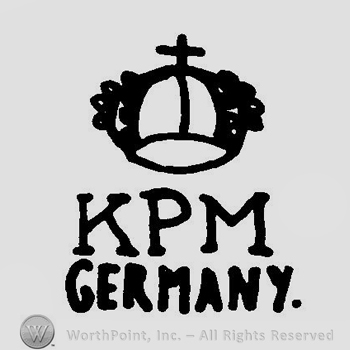 A crown above the initials K P M Krister Germany