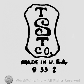 from top to bottom capital letters TST CO inside a stylish rectangle MADE IN USA under 9 39 2 under