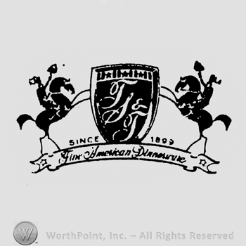 stylish TST initials in white on a black shield between two horses underlined by a ribbon containing handwriting