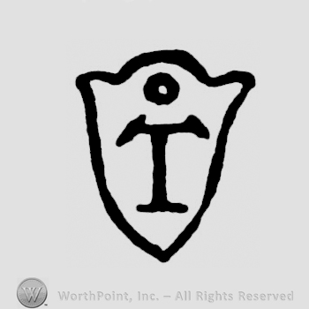 An uppercase T on a shield