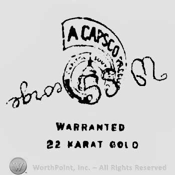 W.S. George written upside down over a ribbon with A Capsco written on it surrounding a Capitol shape, above Warranted written above 22 Karat Gold