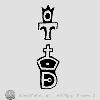 A crown above a T above a cross and a D shape