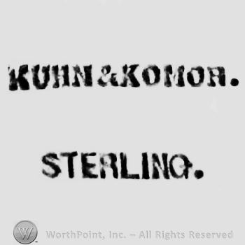 Words KUHN & COMOR STERLING.