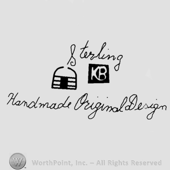Sterling written on top;KB in the middle;Handmade Original design below.