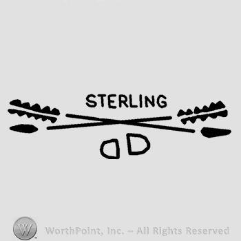 Two crossed arrows,letter D and word Sterling below.