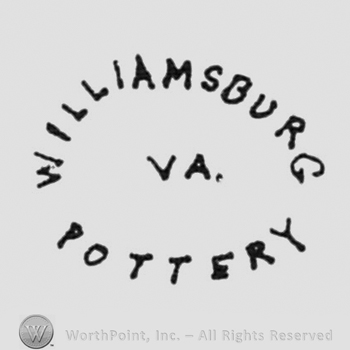 curved writings that form an oval: WILLIAMSBURG POTTERY, VA. Written in the middle