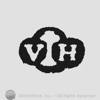 Letters VH in uppercase split by a tree.