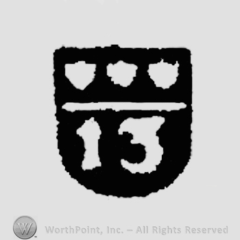 A shield with three flower buds over number 13.