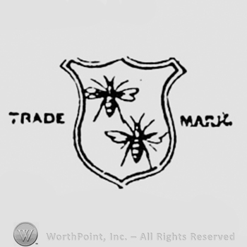 Two flies on a shield and TRADE MARK written one side and another.