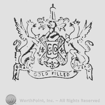 Double C over a shield, between two winged dragons; GOLD FILLED written bellow.