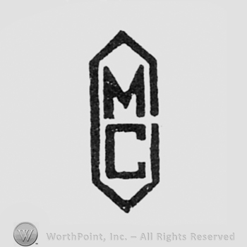 Letters M and C inside a diamond.