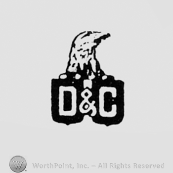 Eagle head above letters D & C.