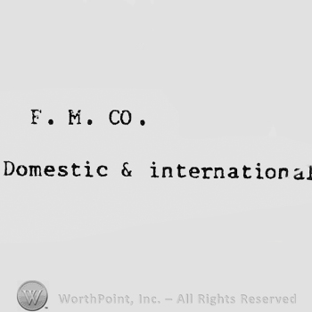 Letters F, M and CO written above words DOMESTIC & INTERNATIONAL.