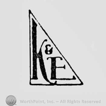 Letters K and E inside a triangle.
