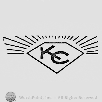Letters K and C inside a diamond.