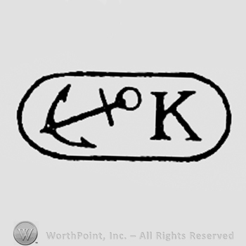 Anchor and letter K inside an oval.