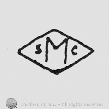 Leters S,M,C inside a diamond.