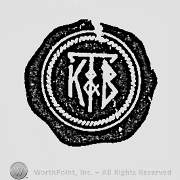 Letters T,K & B inside a circle.