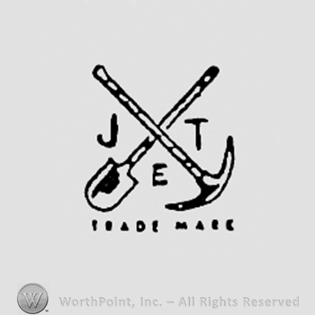 Shovel and pick, and letters J,E,T; TRADE MARK written bellow.