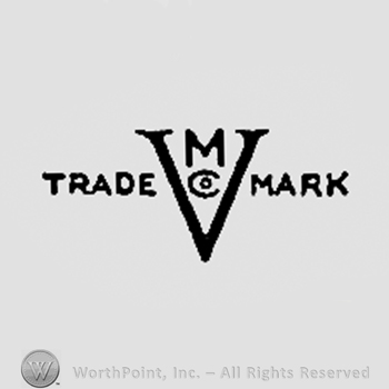 Letters M, CO inside letter v; TRADE MARK written one side and another.