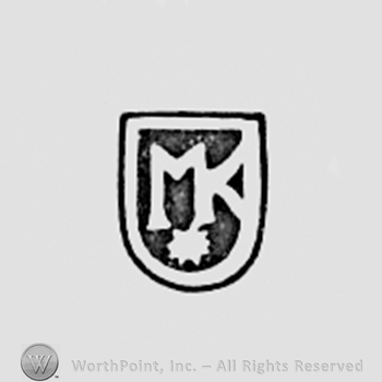 Monogram of letters MK inside a shield shape.