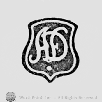 Monogram of letters AD inside a shield shape.