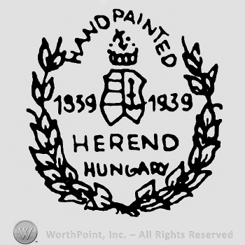 Shape made from a crown and a shield in the middle with number 1939 and Herend Hungary written below;Handpainted on top;branches on sides.