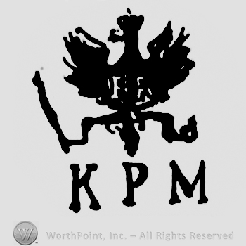 An eagle with crown and scepter;letters KPM below.