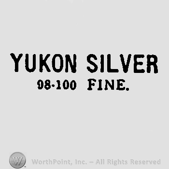 Words ,,yukon silver" written with uppercase letters, number 98 minus number 100 and Fine written with uppercase letters below