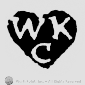The letters WKC written in uppercase, placed on two rows in a heart-shaped background