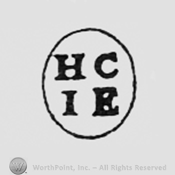 Letters HC and IE inside an oval.