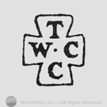 Letters T W C C arranged like a cross.