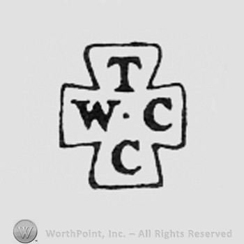 Letters T W C C arranged like a cross.