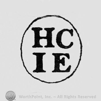 Letters HC IE inside an oval.