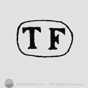 Letters TF inside a frame like an oval.