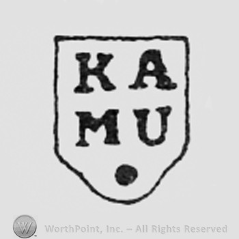 Letters KA MU on a shape like a shield.