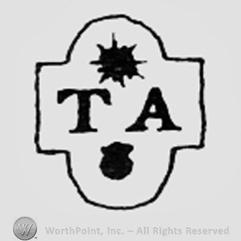 Shape like a sun, letters TA and a dot.