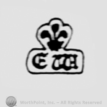 Fleur-de-lis above letters EW.