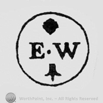 Letters EW, dot and fleur-de-lis, all inside a circle.
