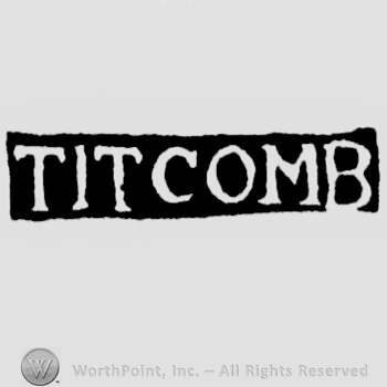 The name Titcomb written with uppercase letters