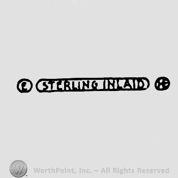 Sterling Inlaid written with uppercase letters inside an oval, uppercase E inside a circle on the left, uppercase H inside a circle on the right
