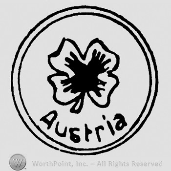 A flower and word Austria written inside a circle.