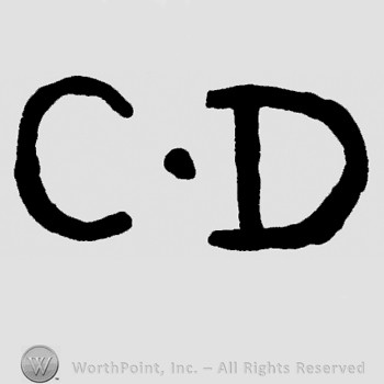 Letters C.D and a dot.