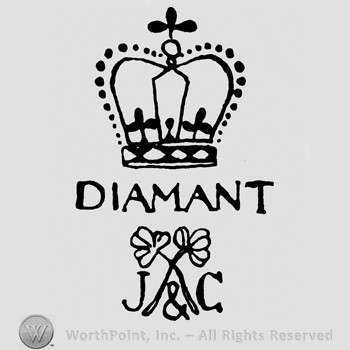 Crown with cross on top;DIAMANT written in the middle;two crossed flowers and JC at the bottom.